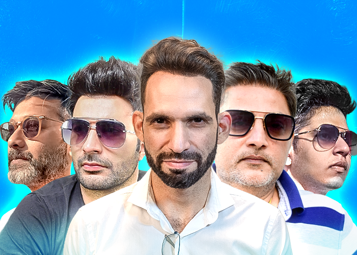 Alt text: A group of five men, each with different hairstyles, standing confidently against a bright blue background. They are wearing sunglasses and have various facial hair styles, giving them a stylish and modern appearance. The man in the center is slightly in front, with a focused expression, while the others are positioned around him, creating a dynamic and cohesive group image.